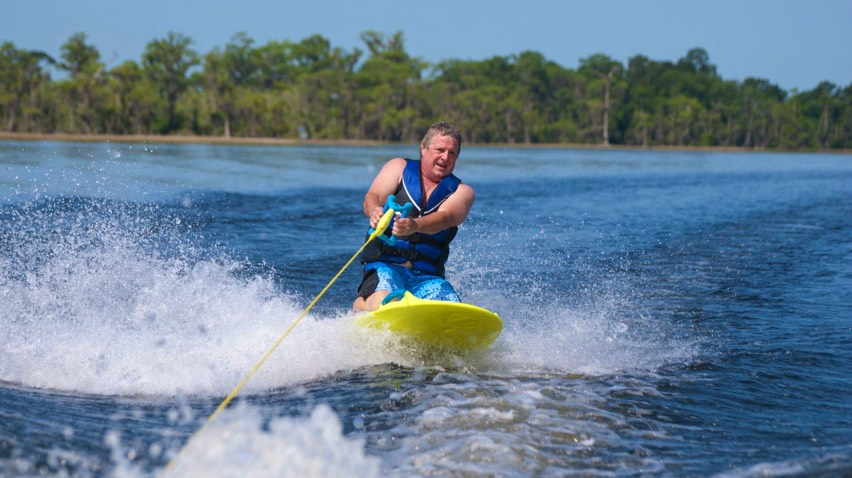 Kneeboarding on ZUP board during watersports lesson